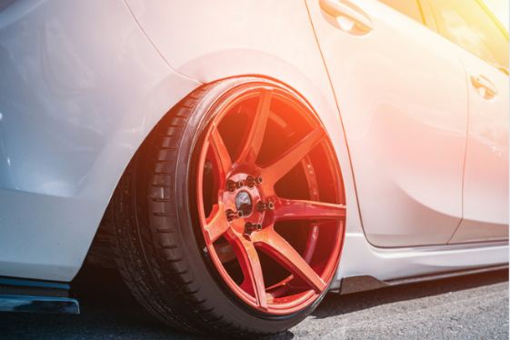 Custom red wheel fitted to a white vehicle